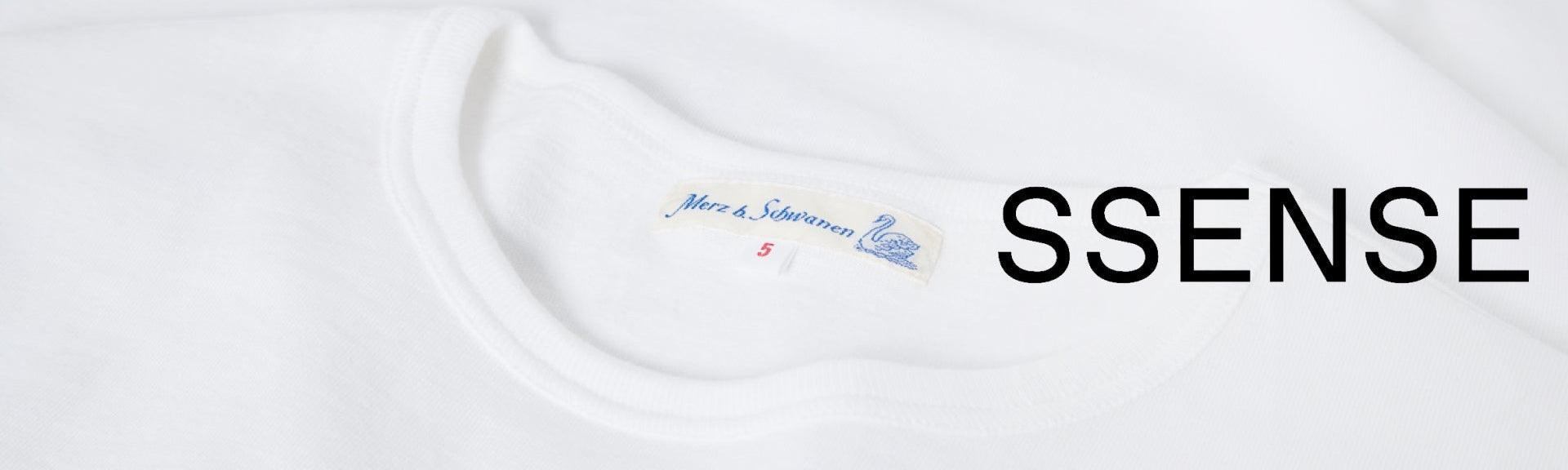 Merz b. Schwanen white T-shirt with brand label, next to the SSENSE logo