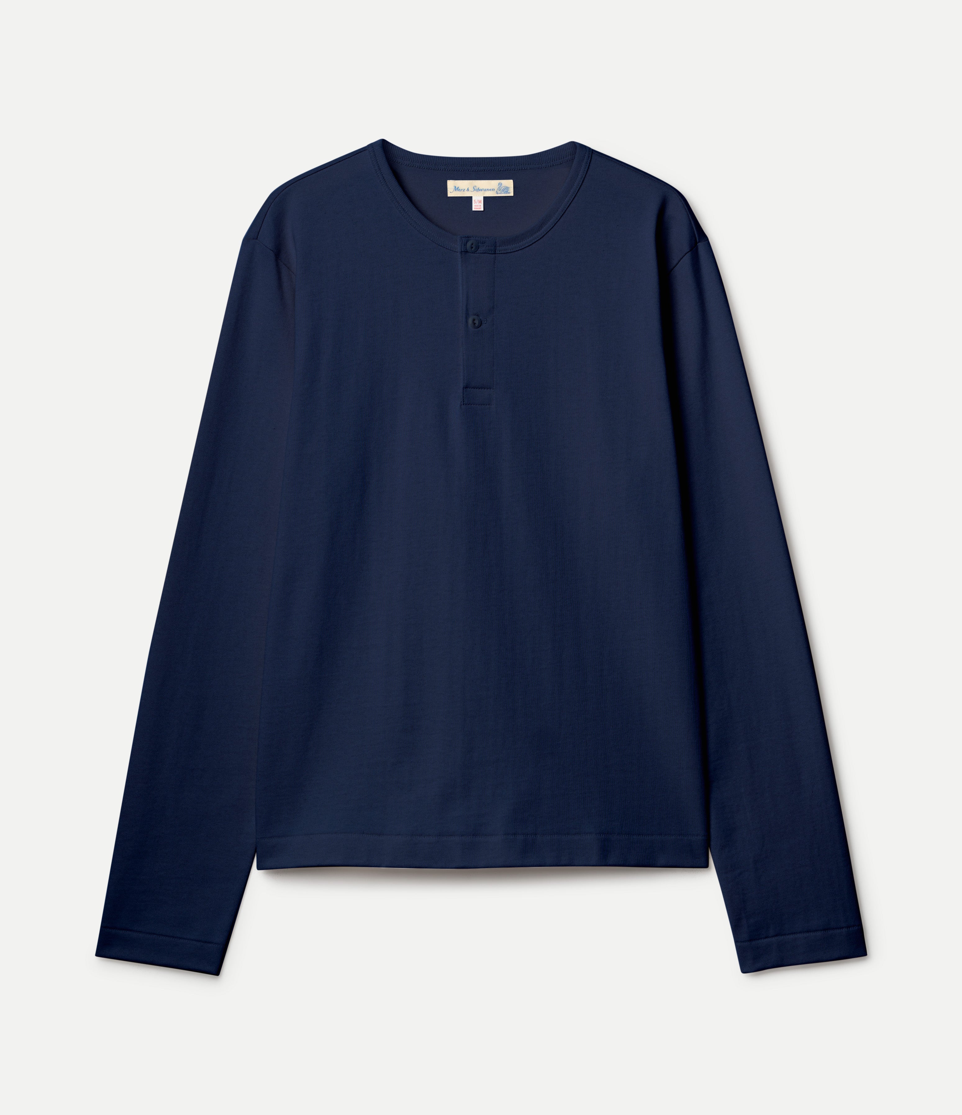 A navy blue cropped long-sleeve henley shirt with a three-button placket, displayed flat against a light off-white background.