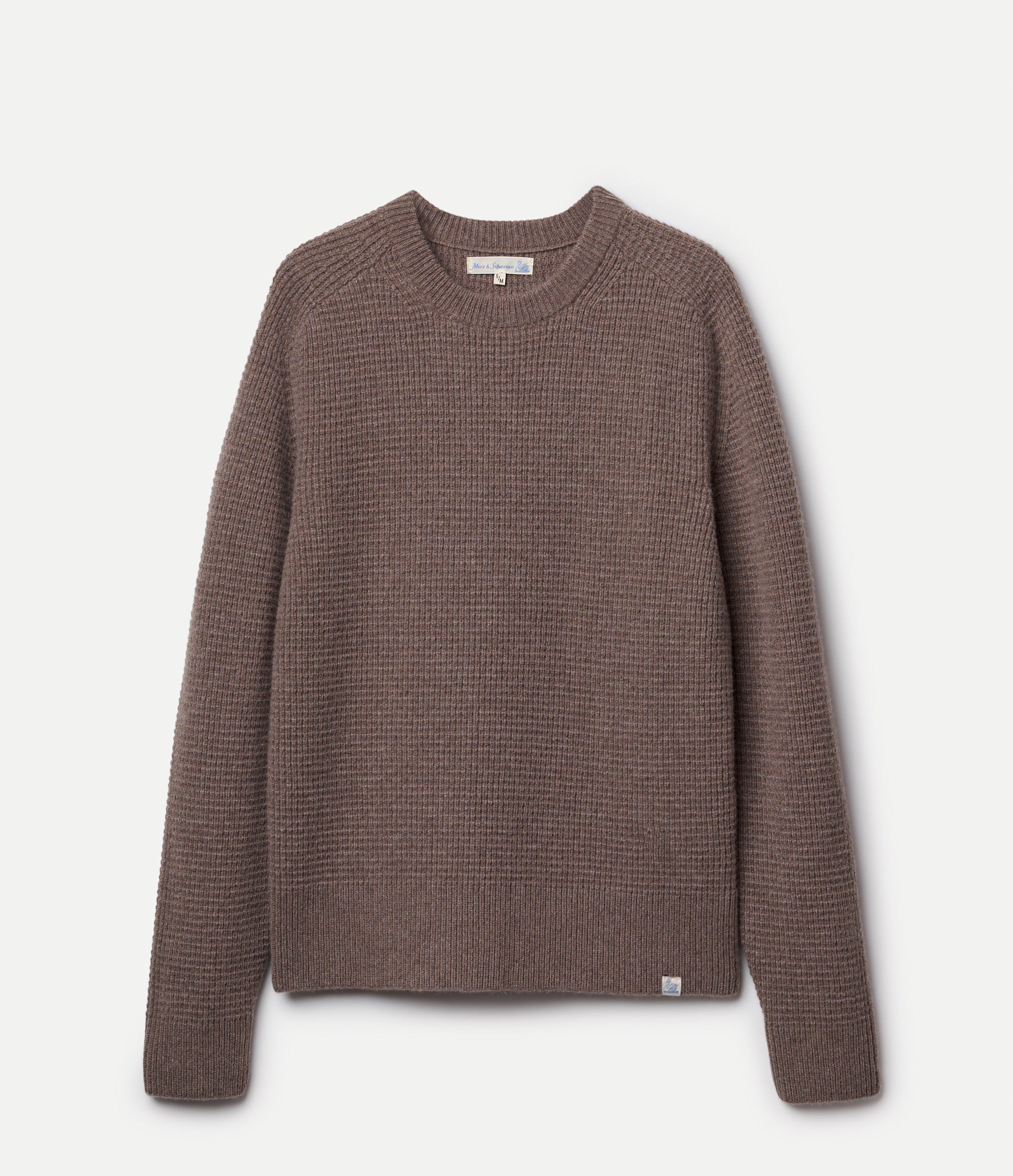 Brown textured sweater on a light beige background