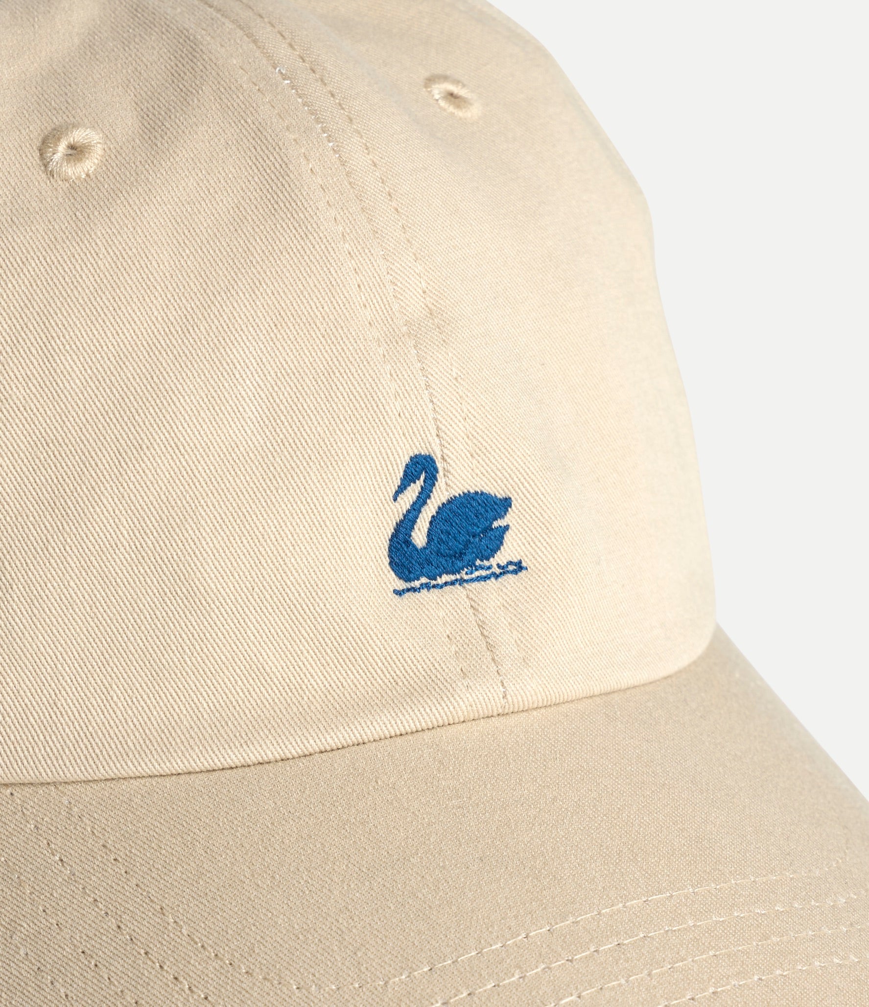 Beige cap with a blue swan logo on a white background