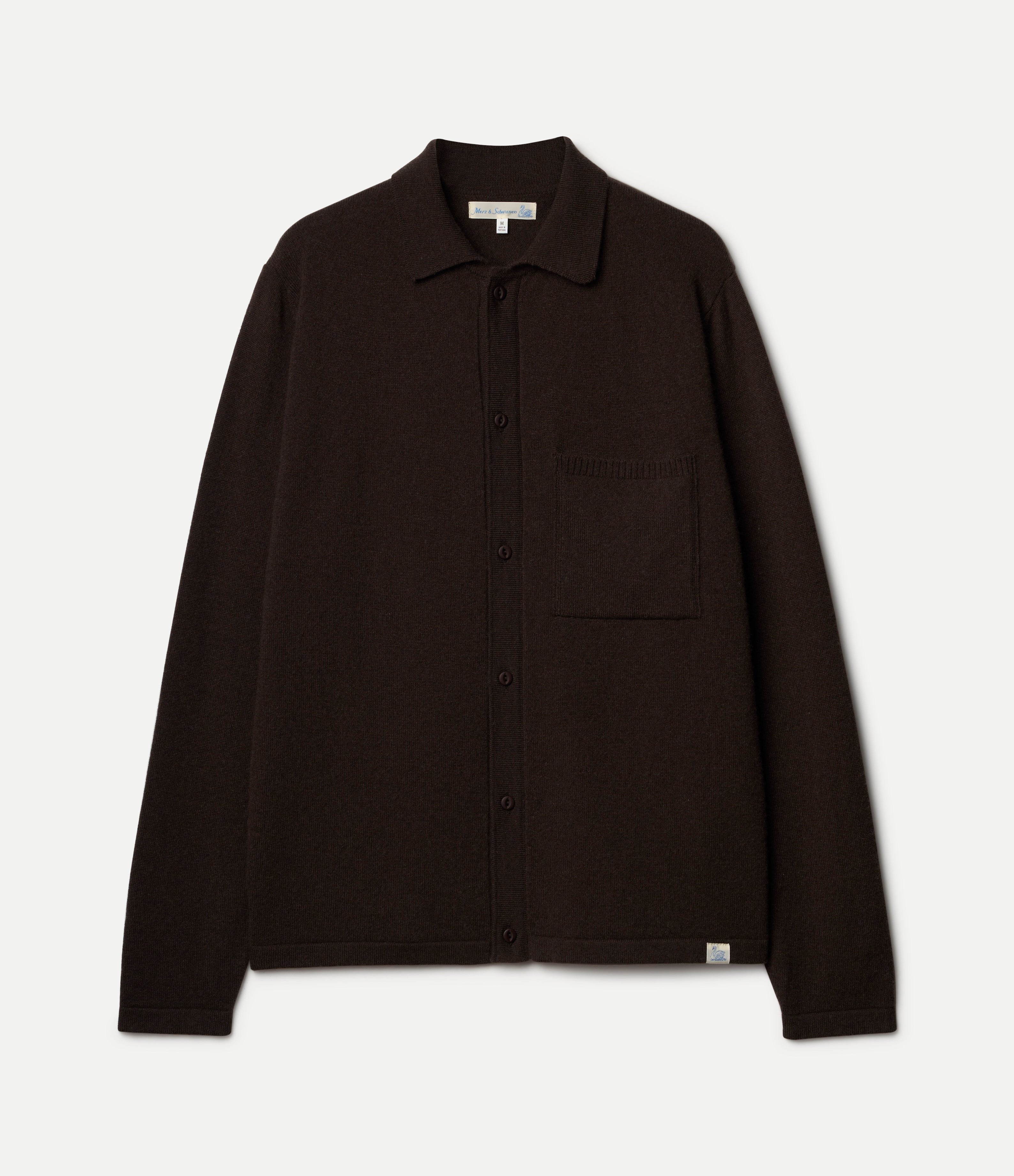 A dark brown long-sleeve button-up knitted shirt with a collar and a chest pocket, shown flat against a light off-white background.