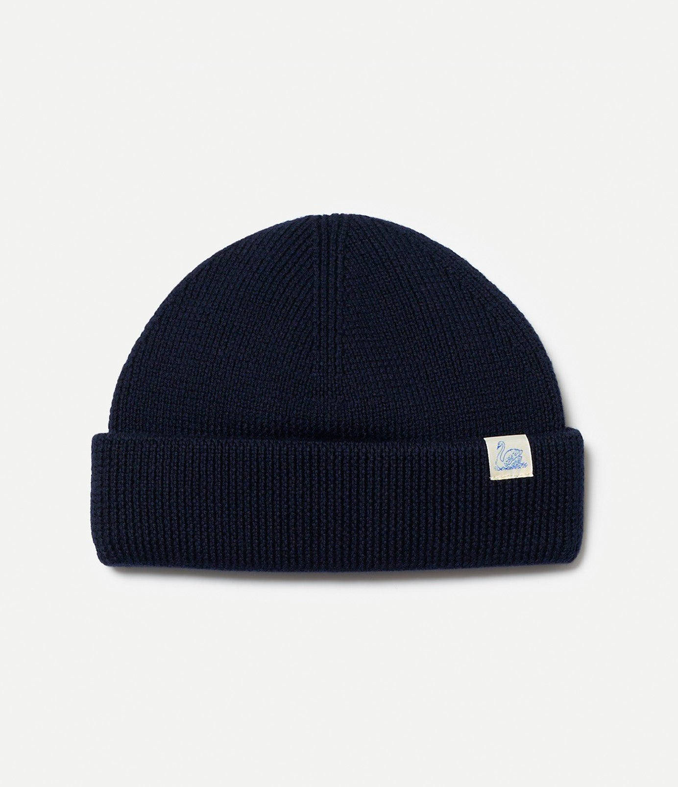 Navy blue merino wool beanie with a Swan brand logo on a light gray background