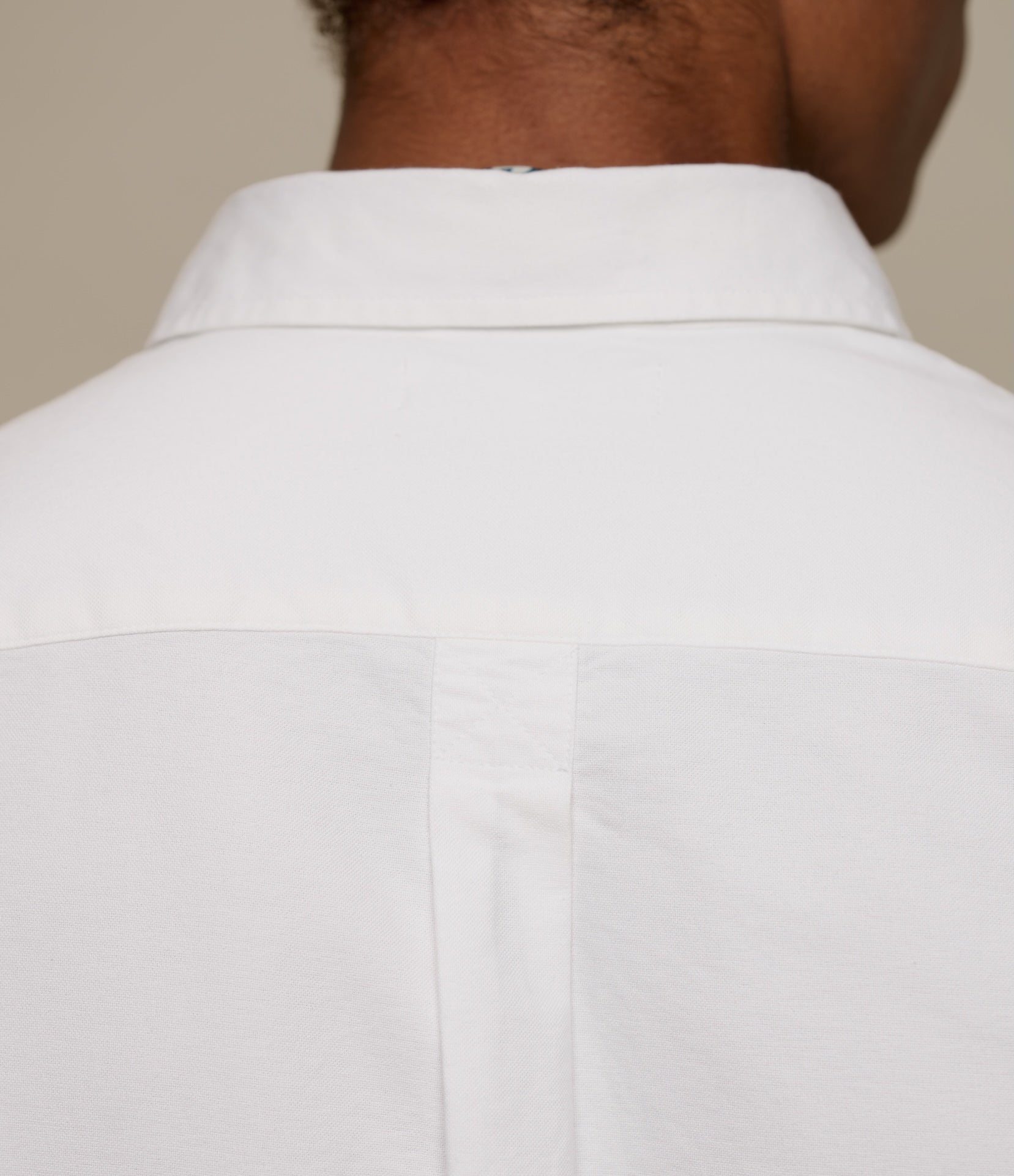 White dress shirt worn by a person with a neutral background