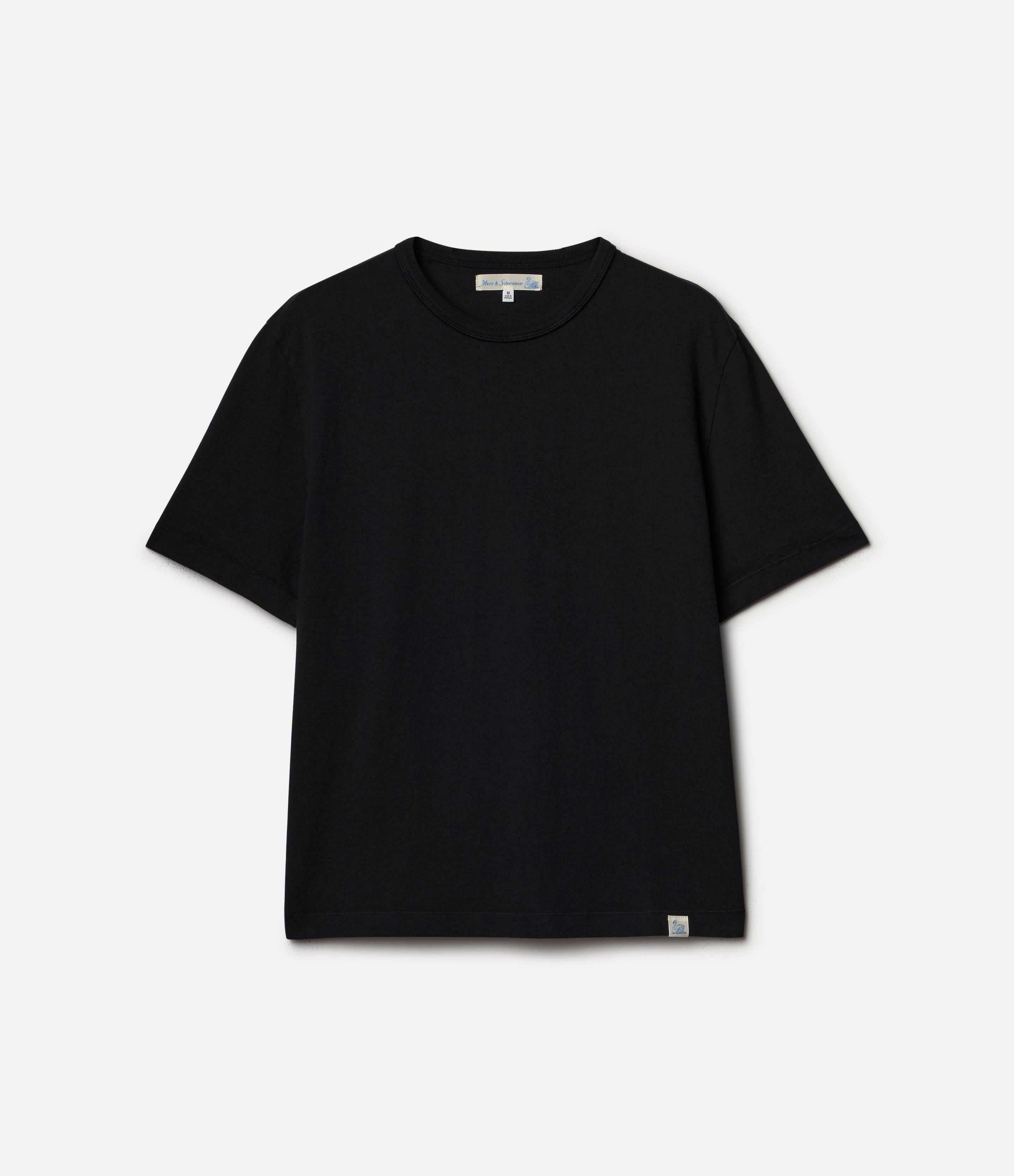 A black short-sleeve crewneck t-shirt with a small white tag on the bottom hem and a white brand label inside the collar, displayed flat against a light gray background.