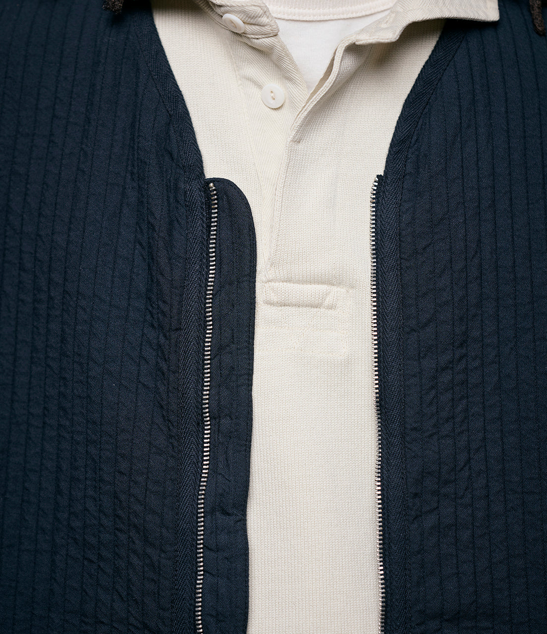 Close-up shot of black padded vest with zipper