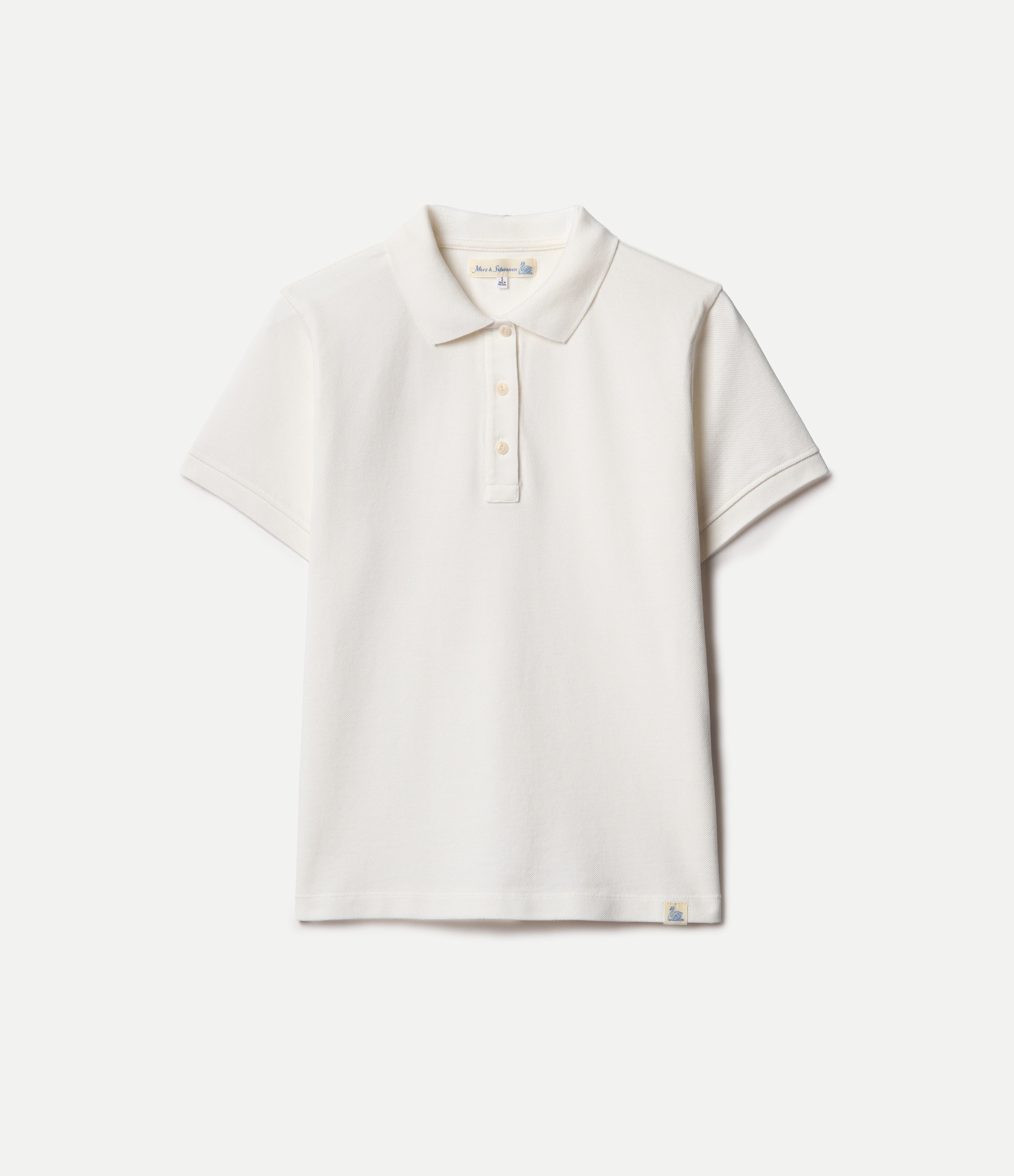 White polo pikée polo shirt on a light beige background